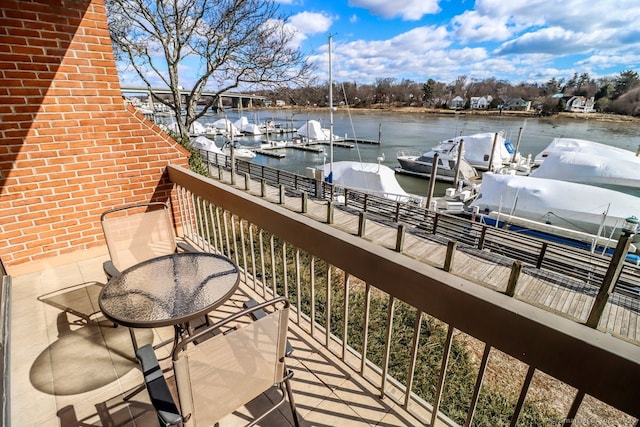 balcony featuring a water view and a boat dock