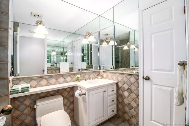 full bath with vanity, tile walls, toilet, and an enclosed shower