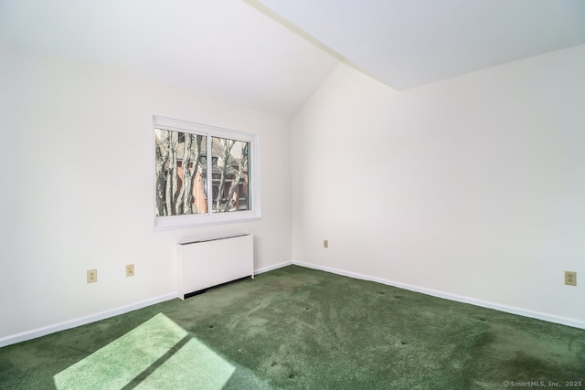 unfurnished room featuring carpet flooring, radiator, baseboards, and vaulted ceiling