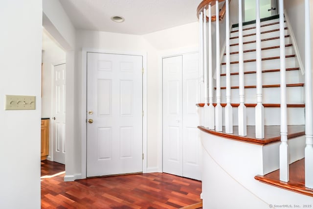 interior space featuring dark wood finished floors and stairs