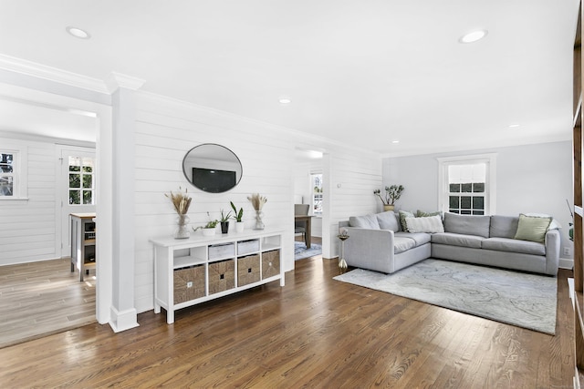 living area featuring recessed lighting, ornamental molding, and wood finished floors