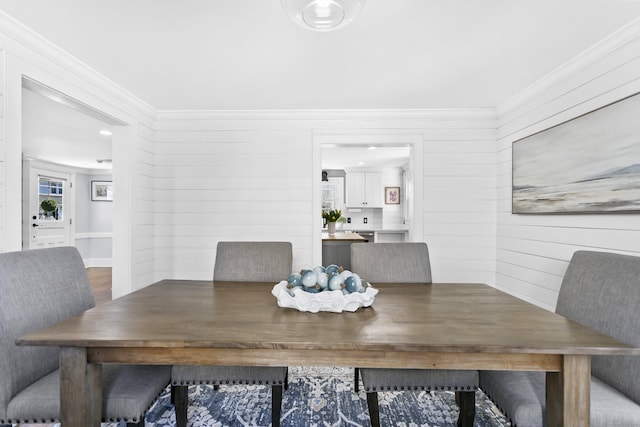 dining space with crown molding
