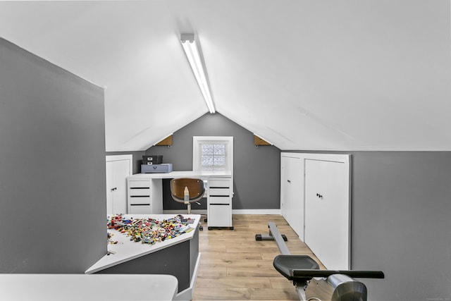 bonus room featuring lofted ceiling, baseboards, and light wood-type flooring