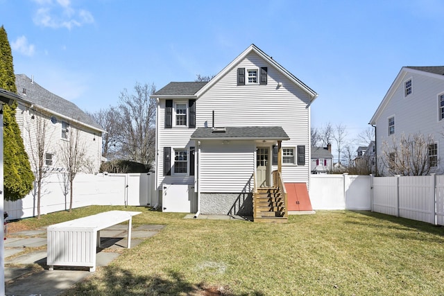 rear view of property featuring a gate, a fenced backyard, a shingled roof, entry steps, and a lawn