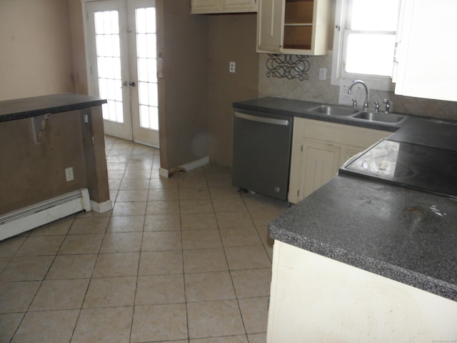 kitchen with a sink, backsplash, dark countertops, light tile patterned flooring, and dishwasher