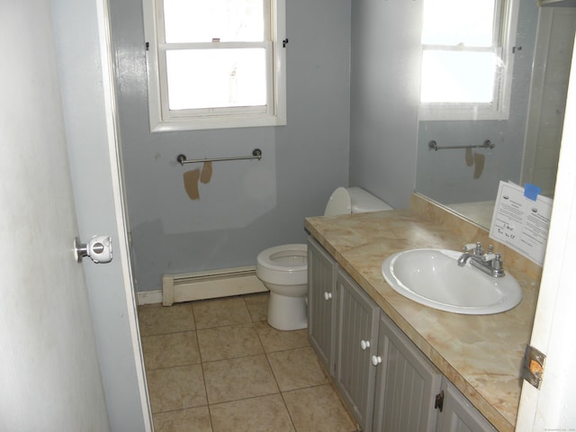 bathroom with tile patterned flooring, toilet, vanity, and a baseboard radiator