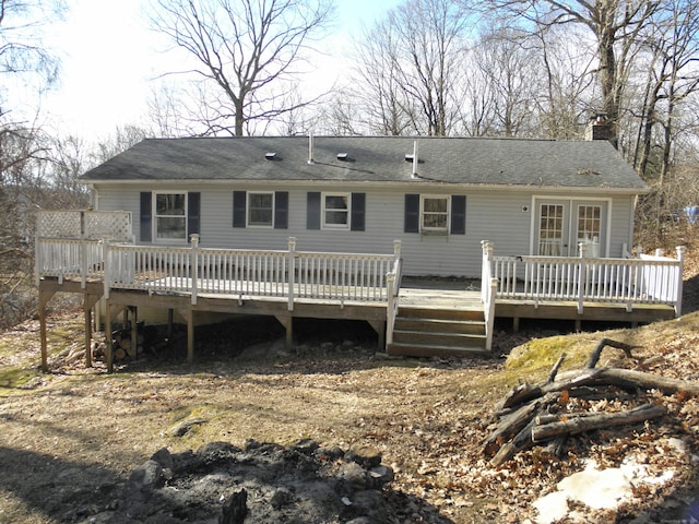 back of property with a deck and a chimney