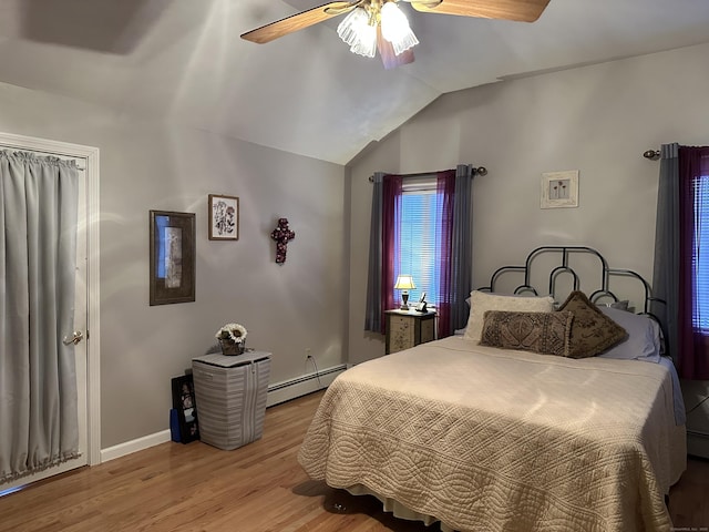 bedroom featuring baseboards, a ceiling fan, a baseboard radiator, wood finished floors, and vaulted ceiling