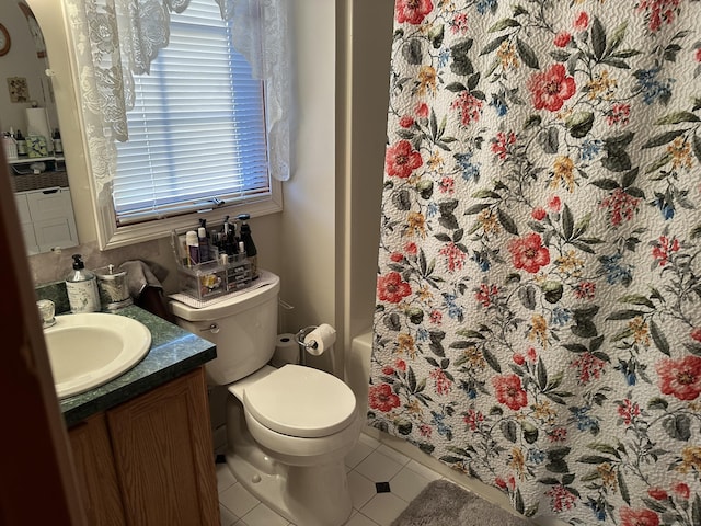 bathroom with toilet, shower / bath combo, tile patterned flooring, and vanity