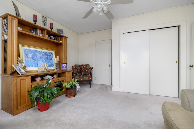 sitting room with light carpet and ceiling fan