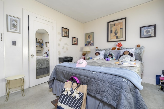 carpeted bedroom with arched walkways