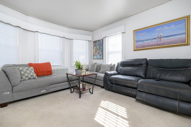 living room featuring light carpet and radiator heating unit