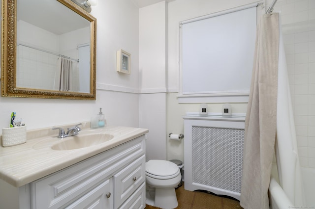 bathroom with toilet, radiator heating unit, shower / bath combo, and vanity