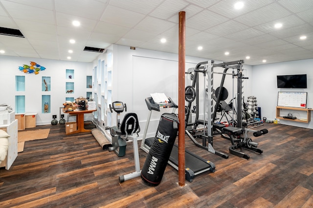 exercise room featuring recessed lighting, visible vents, baseboards, and wood finished floors