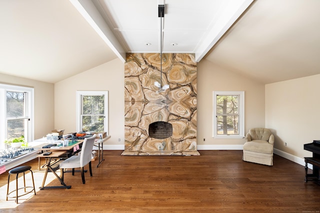 dining area with vaulted ceiling with beams, wood finished floors, and baseboards