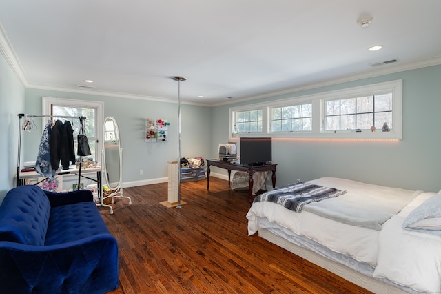 bedroom featuring multiple windows, crown molding, visible vents, and wood finished floors