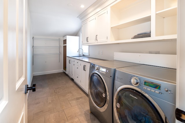 laundry room featuring cabinet space, a sink, and washing machine and clothes dryer