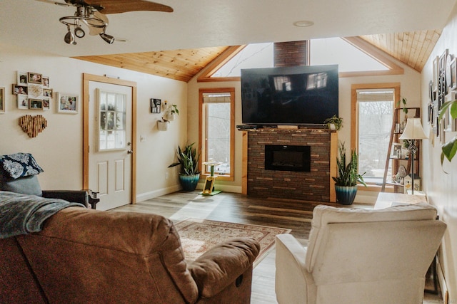 living room featuring lofted ceiling, wooden ceiling, a fireplace, and wood finished floors