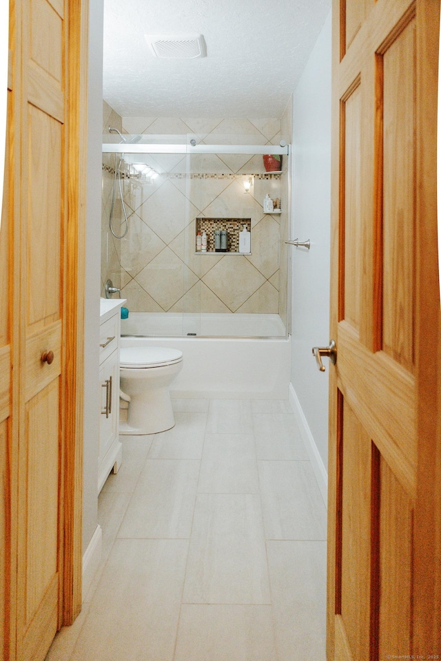 full bath with toilet, enclosed tub / shower combo, vanity, baseboards, and tile patterned floors