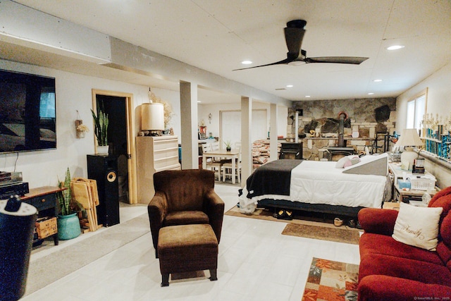 bedroom featuring a wood stove and recessed lighting