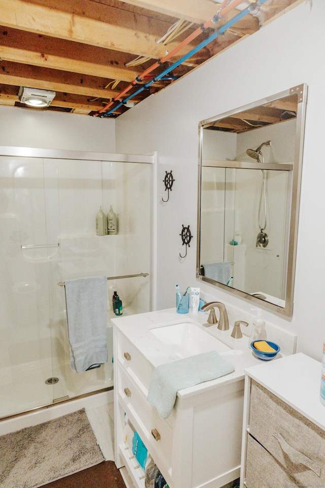 bathroom with a stall shower and vanity