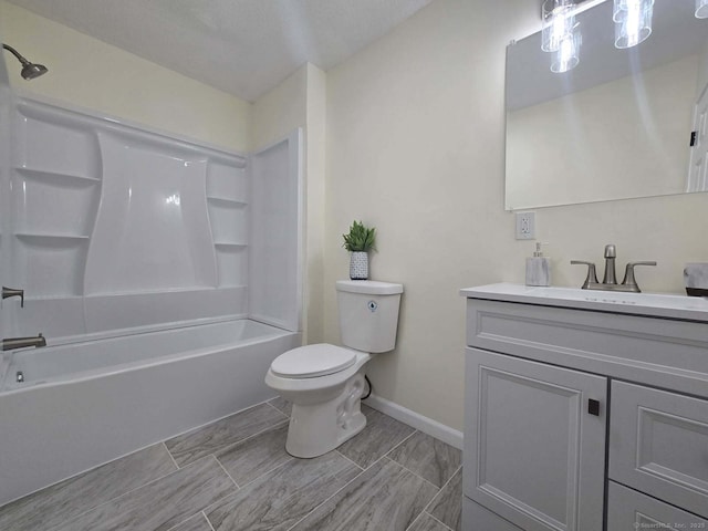 bathroom featuring baseboards, tub / shower combination, vanity, and toilet