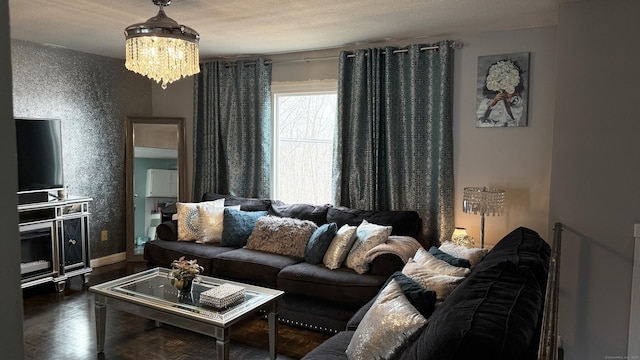 living area featuring parquet floors, a notable chandelier, and baseboards