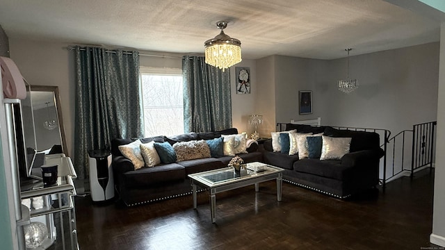 living area with a textured ceiling and an inviting chandelier