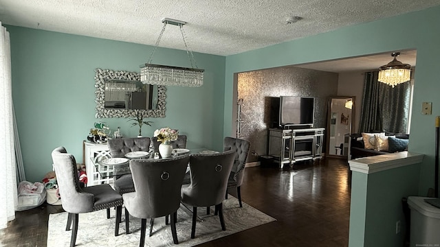 dining space with a textured ceiling and wood finished floors