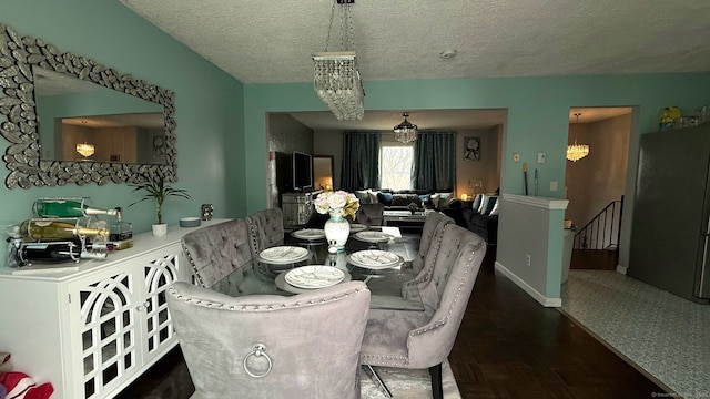 dining area with a chandelier and a textured ceiling