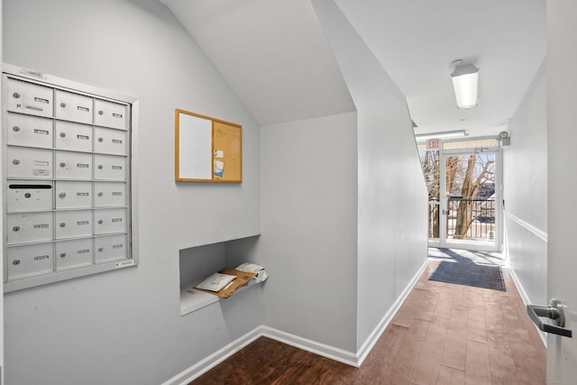 hall featuring mail area, baseboards, and wood finished floors