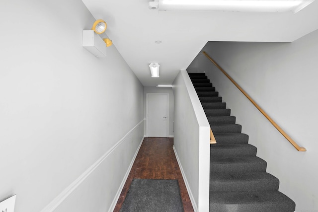 stairs with baseboards and wood finished floors