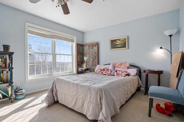 bedroom featuring carpet, a ceiling fan, and baseboards