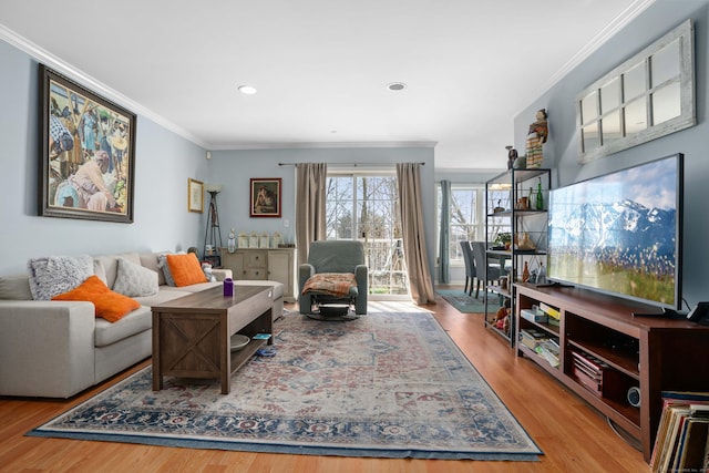 living area with ornamental molding, wood finished floors, and recessed lighting