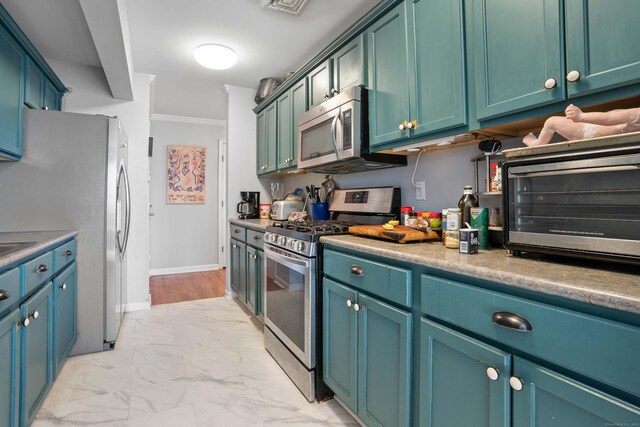 kitchen featuring a toaster, ornamental molding, marble finish floor, stainless steel appliances, and light countertops