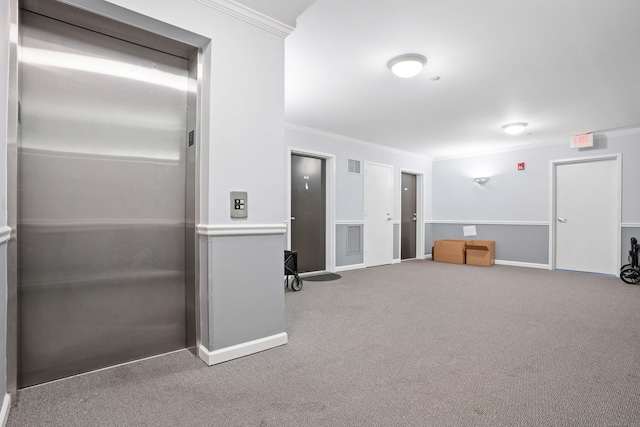 interior space with visible vents, baseboards, elevator, carpet, and crown molding