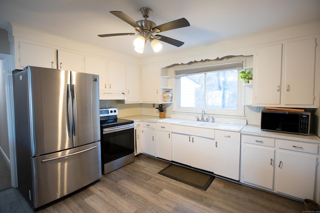 kitchen featuring appliances with stainless steel finishes, open shelves, a sink, and light countertops