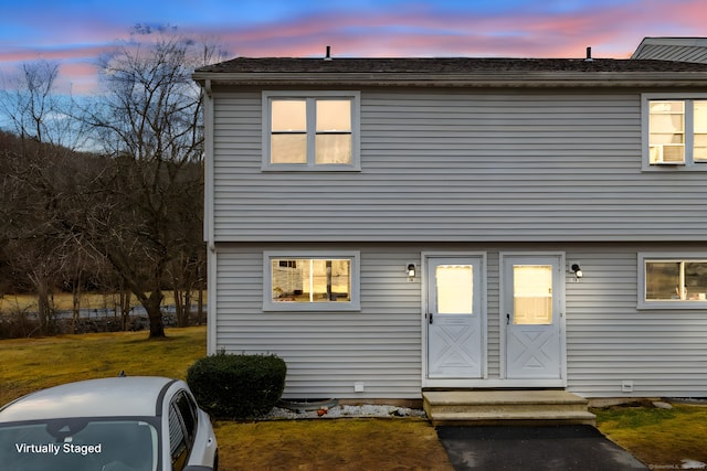 view of front of property with a lawn and entry steps