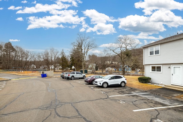 uncovered parking lot with a residential view