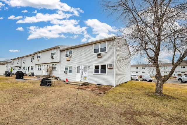 back of property featuring a yard and a residential view