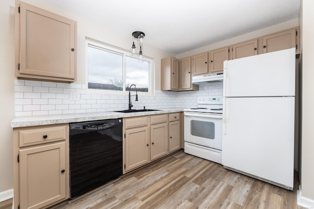 kitchen with white appliances, a sink, decorative backsplash, light countertops, and under cabinet range hood