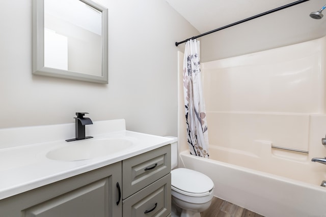 full bath featuring vanity, toilet, shower / tub combo with curtain, and wood finished floors