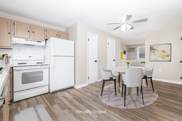 kitchen featuring decorative backsplash, white appliances, light wood-style flooring, and under cabinet range hood