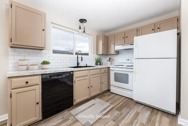 kitchen featuring white appliances, a sink, light countertops, under cabinet range hood, and tasteful backsplash