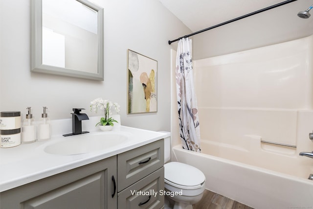 full bathroom with vanity, toilet, wood finished floors, and shower / bath combo