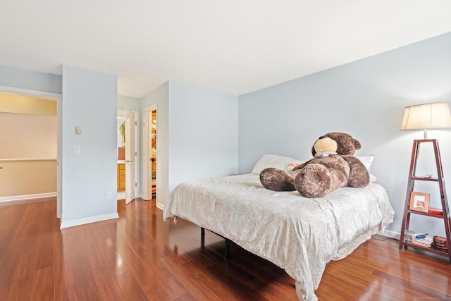 bedroom featuring wood finished floors and baseboards