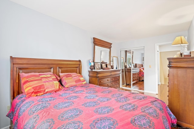 bedroom featuring wood finished floors and baseboards