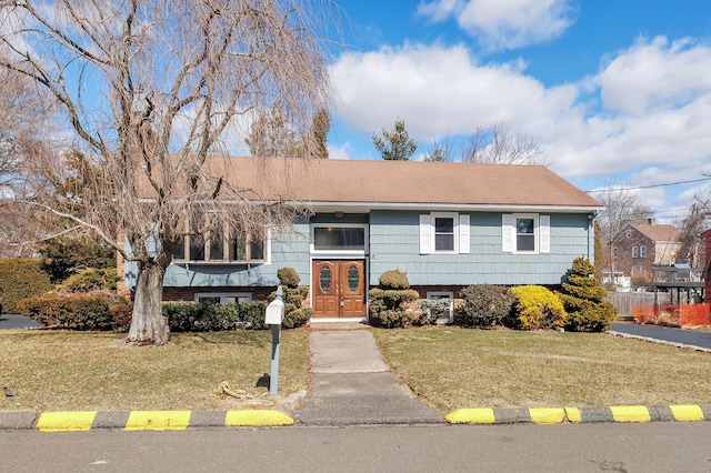 bi-level home with a front lawn