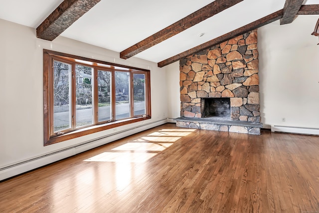 unfurnished living room featuring vaulted ceiling with beams, a fireplace, a baseboard heating unit, and wood finished floors