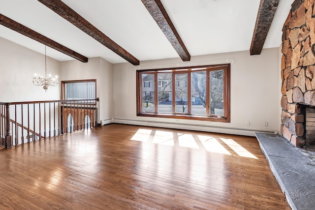 unfurnished living room featuring beam ceiling, a fireplace, a baseboard radiator, a chandelier, and hardwood / wood-style floors